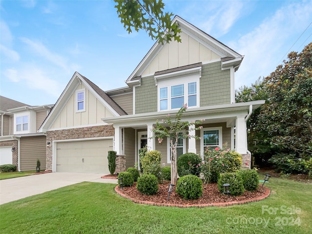 craftsman-style house featuring a porch, a garage, and a front lawn