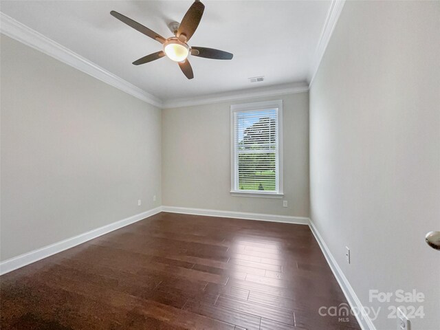 spare room featuring dark hardwood / wood-style floors, crown molding, and ceiling fan