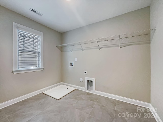 washroom with gas dryer hookup, hookup for a washing machine, electric dryer hookup, and tile patterned flooring