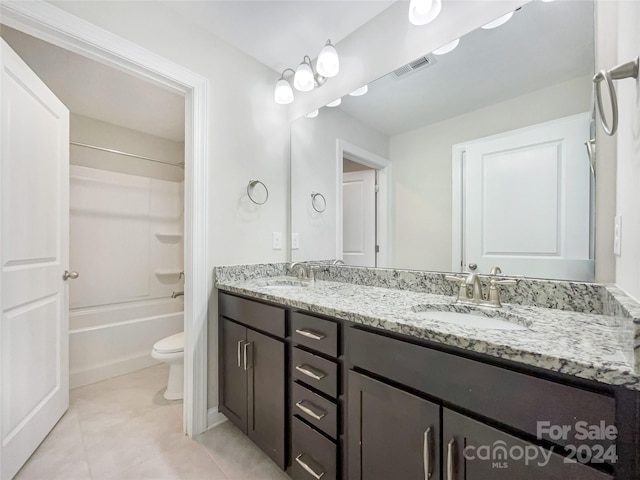 full bathroom featuring toilet, tile patterned floors,  shower combination, and double vanity