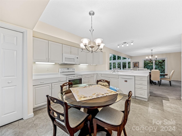 dining area featuring an inviting chandelier, sink, and a textured ceiling