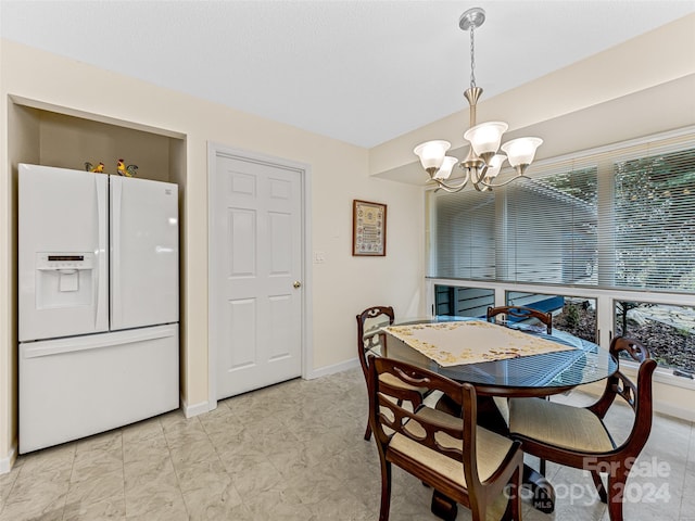 dining area featuring plenty of natural light and a chandelier