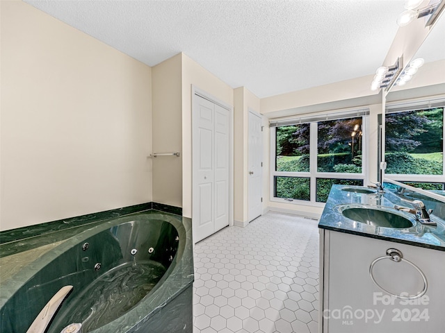 bathroom with tile patterned flooring, double vanity, and a textured ceiling