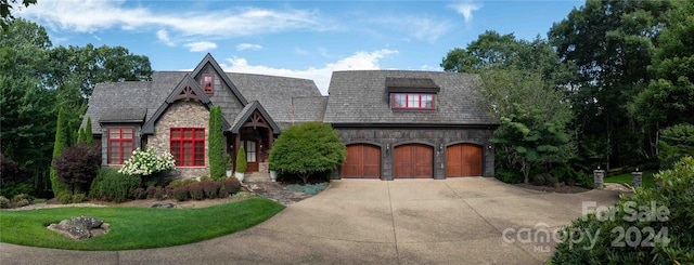 view of front of house featuring a garage and a front lawn