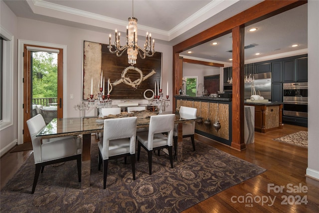 dining room with a tray ceiling, ornamental molding, and dark hardwood / wood-style floors