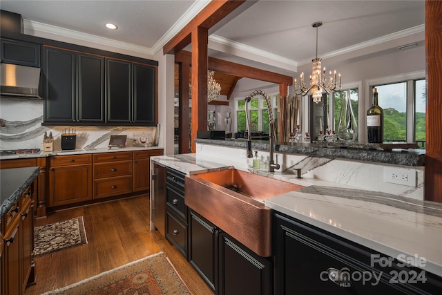 kitchen with sink, crown molding, dark hardwood / wood-style floors, tasteful backsplash, and light stone countertops