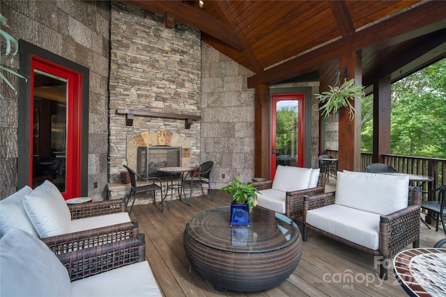 deck featuring an outdoor living space with a fireplace