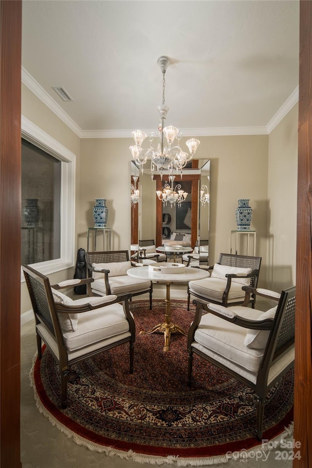 sitting room with ornamental molding and a notable chandelier