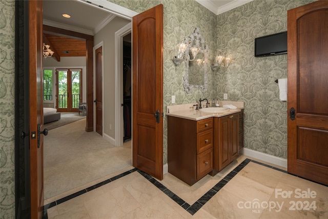 bathroom featuring crown molding and vanity