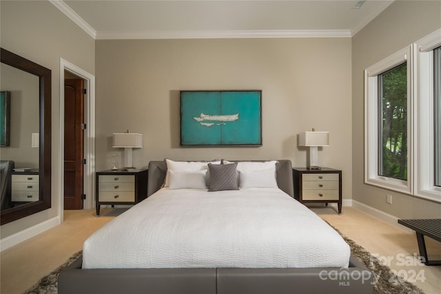 carpeted bedroom with ornamental molding