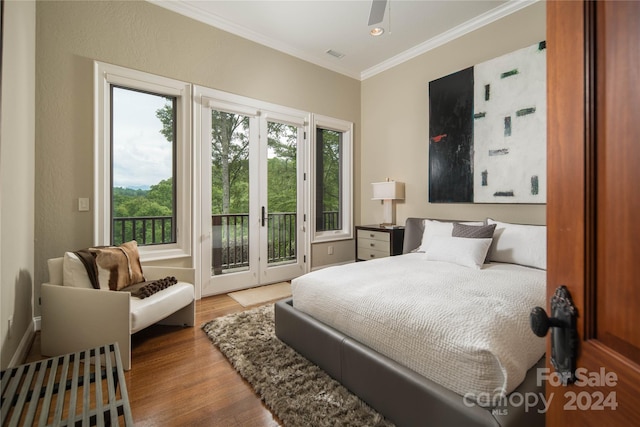 bedroom featuring ornamental molding, access to exterior, and light wood-type flooring