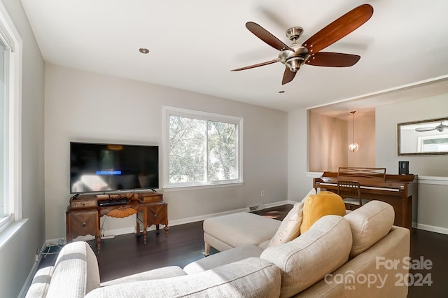 living room featuring ceiling fan and dark hardwood / wood-style flooring