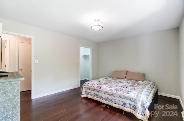 bedroom with dark hardwood / wood-style floors