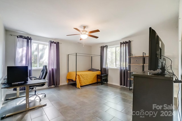 bedroom featuring multiple windows and ceiling fan