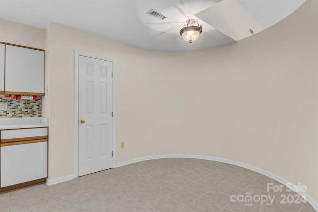 spare room with visible vents and baseboards