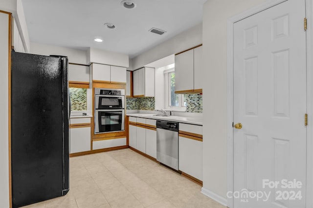 kitchen featuring visible vents, a sink, appliances with stainless steel finishes, white cabinets, and light countertops