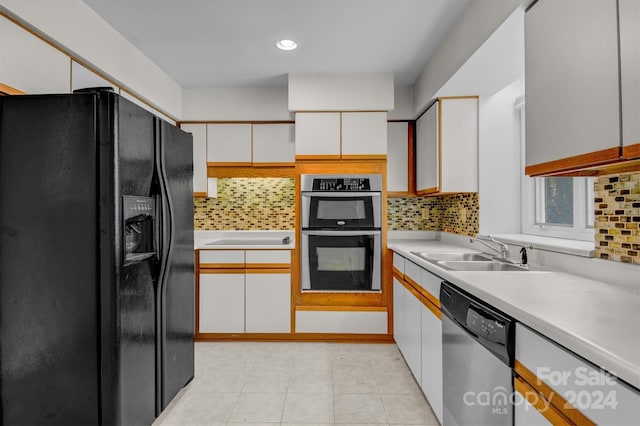 kitchen with a sink, white cabinetry, appliances with stainless steel finishes, and light countertops