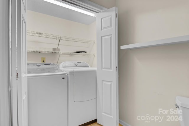 clothes washing area with laundry area and washer and dryer