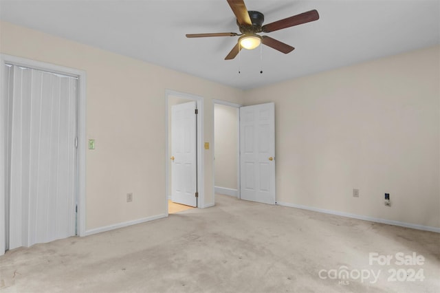 unfurnished bedroom featuring baseboards, carpet, and ceiling fan