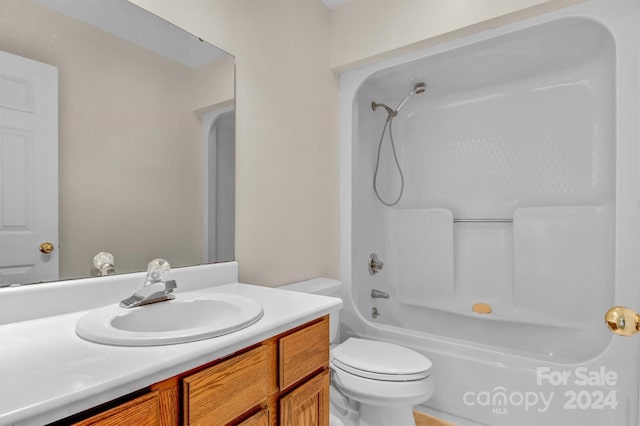 bathroom featuring vanity, toilet, and washtub / shower combination