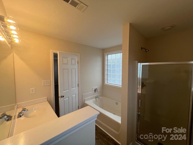 bathroom with vanity and plus walk in shower