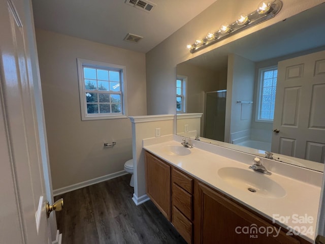 full bathroom with toilet, wood-type flooring, shower with separate bathtub, and vanity