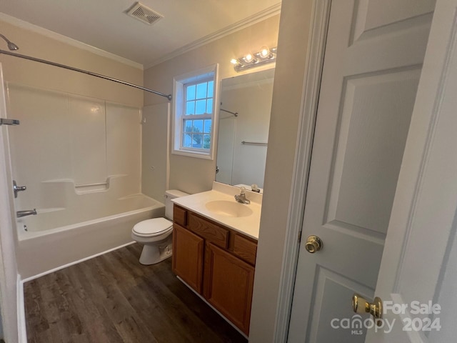 full bathroom with hardwood / wood-style flooring, shower / tub combination, vanity, ornamental molding, and toilet