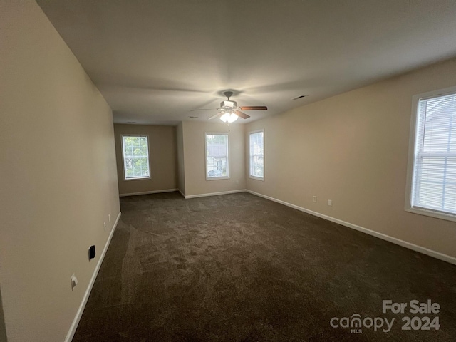 carpeted empty room featuring ceiling fan