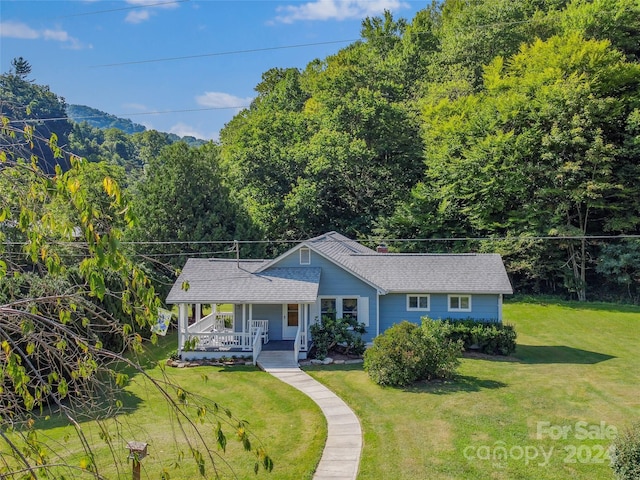 ranch-style home with a front yard and a porch