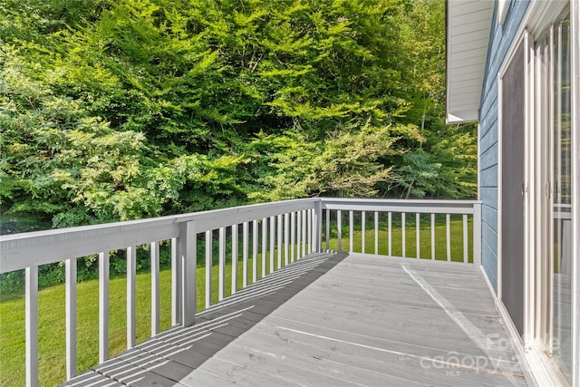 wooden terrace with a yard