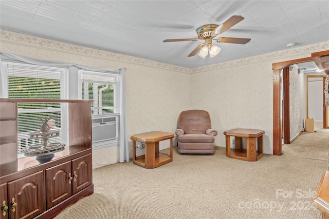 living area with light colored carpet and ceiling fan