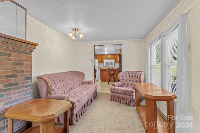 living area with a notable chandelier and light colored carpet