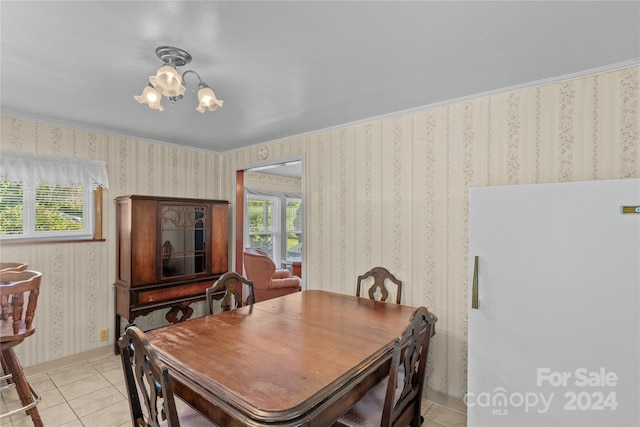 dining area featuring an inviting chandelier, a healthy amount of sunlight, and light tile patterned flooring