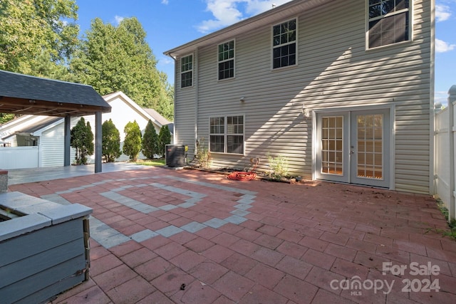 rear view of property featuring central AC, a patio, and french doors