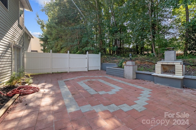 view of patio / terrace featuring exterior fireplace