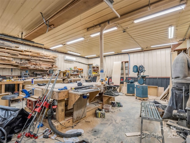 garage with an AC wall unit and a workshop area