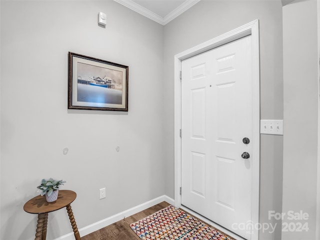 entryway with ornamental molding and wood-type flooring