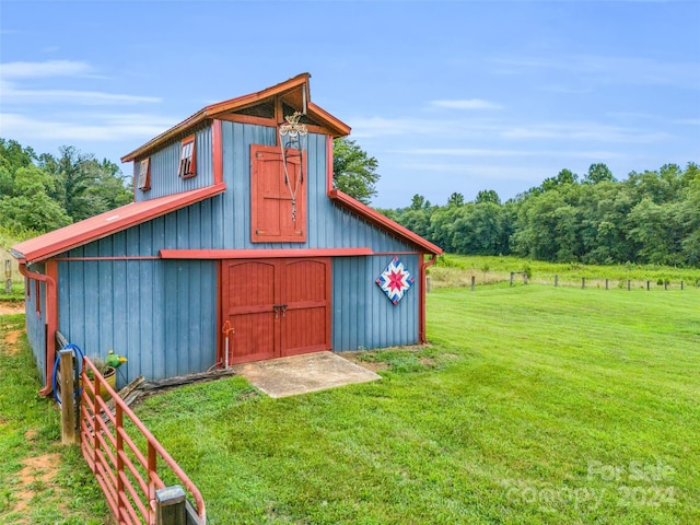 view of outbuilding featuring a lawn