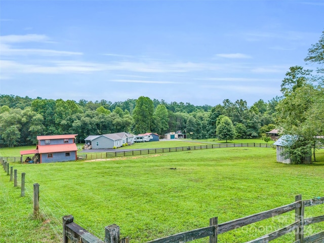 view of yard with a rural view and an outdoor structure