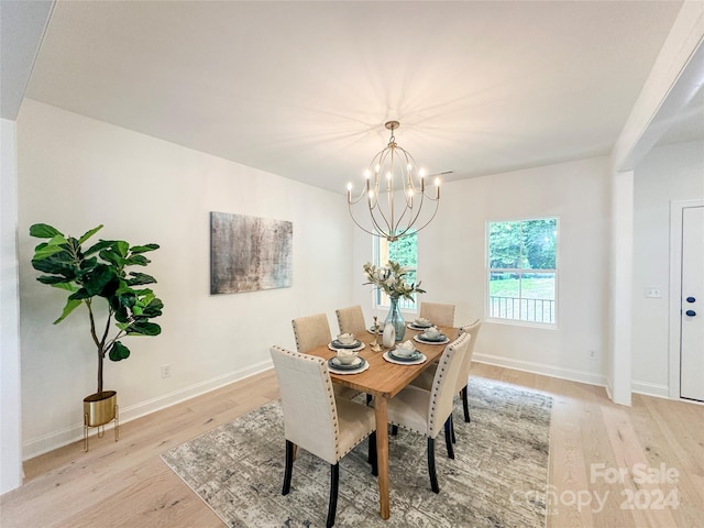 dining room featuring a chandelier and light wood-type flooring