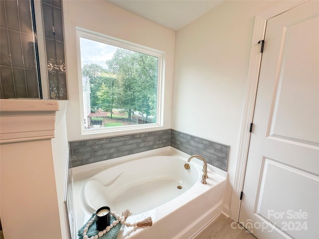 bathroom with a tub to relax in