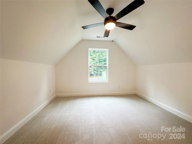 additional living space with lofted ceiling, carpet floors, and ceiling fan