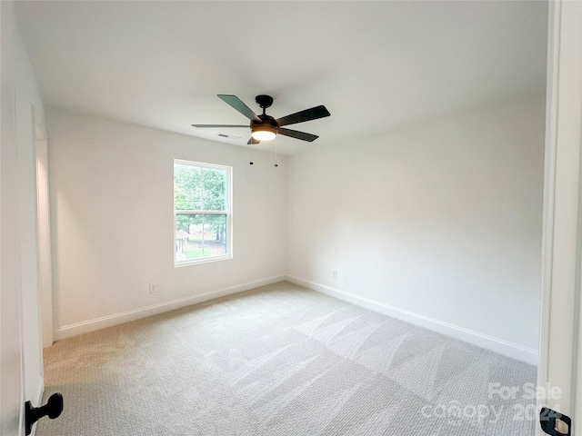 spare room featuring ceiling fan and light carpet