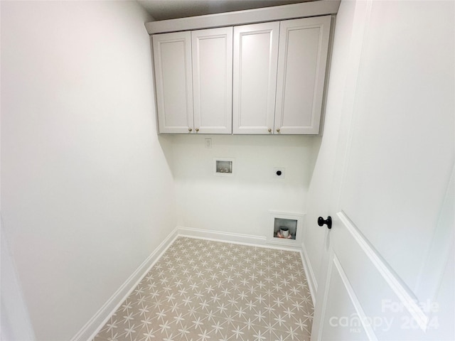 clothes washing area featuring cabinets, electric dryer hookup, and hookup for a washing machine