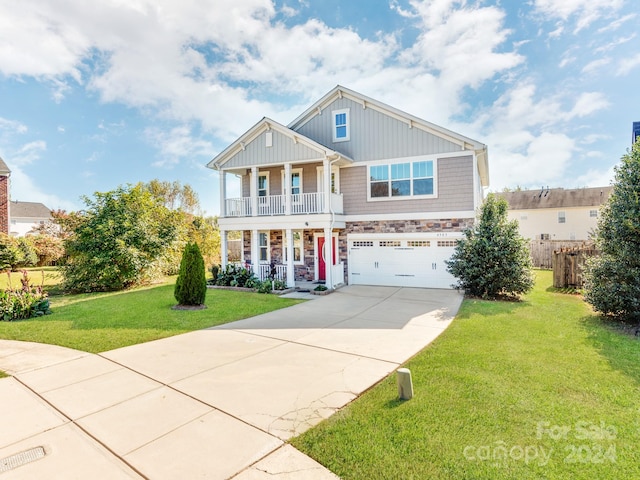 craftsman inspired home featuring a front yard, covered porch, and a garage