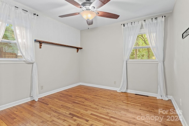 unfurnished room featuring light hardwood / wood-style flooring and ceiling fan