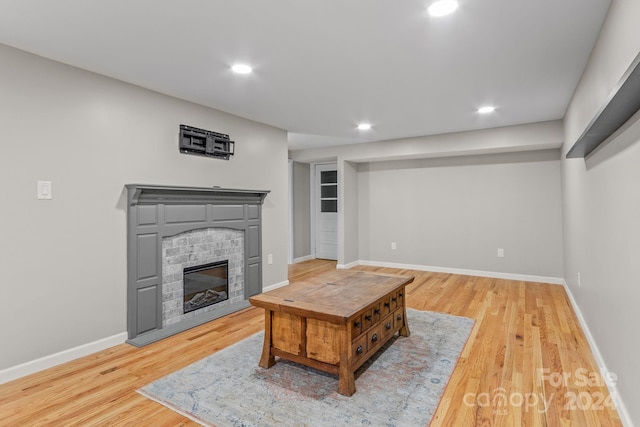 living room featuring a fireplace and light wood-type flooring