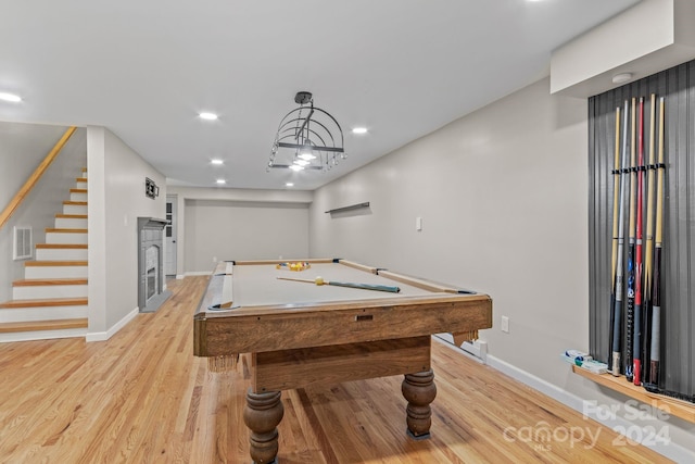 playroom featuring light hardwood / wood-style floors, a fireplace, and billiards