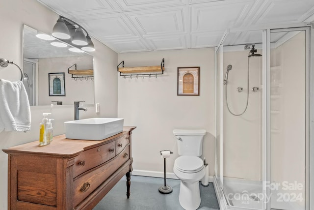 bathroom with vanity, toilet, and a shower with door