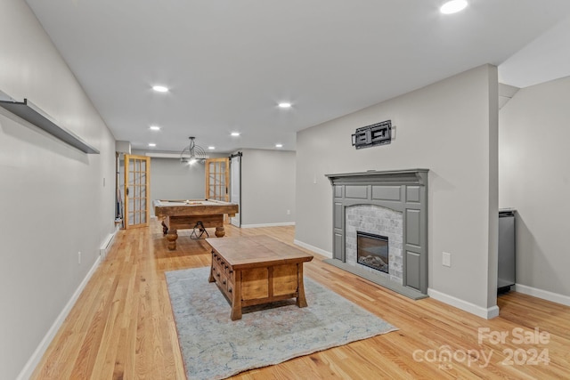 living room with pool table and light wood-type flooring